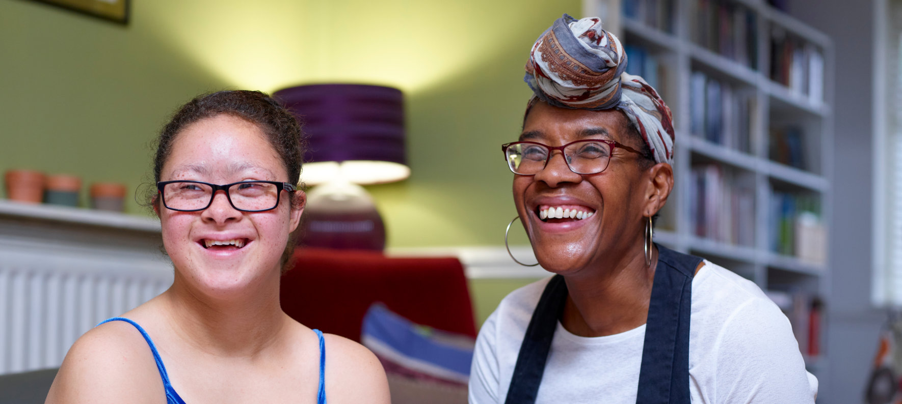 caretaker and cute girl smiling